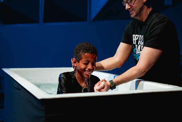 young boy being baptized at baptism bash