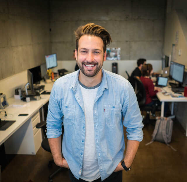 smiling casual man standing in a modern office setting