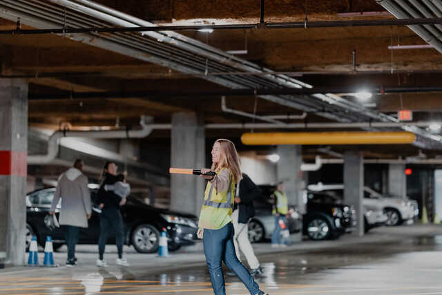 woman directing traffic in the parking deck
