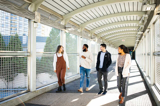 young adults walking on the pedestrian bridge