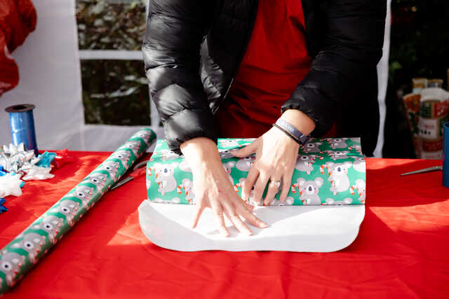 volunteer wrapping presents at a nonprofit