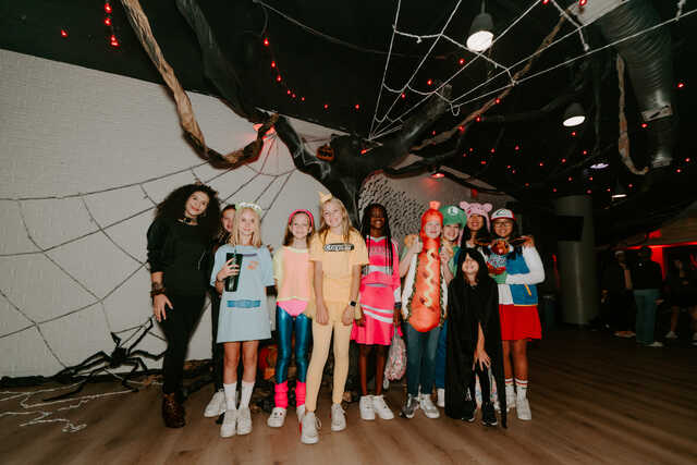 middle school girls small group in halloween costumes