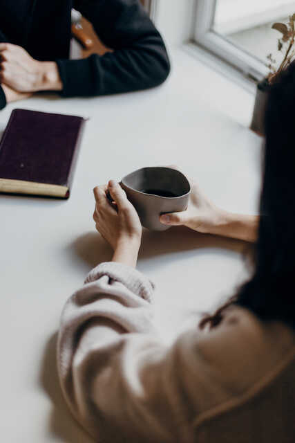 woman with coffee and man with bible